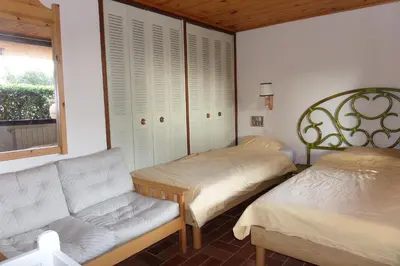 a bedroom with two beds and a couch and a window at Alzina in Vingrau