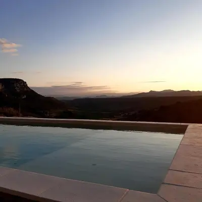 a swimming pool with a view of the mountains at Alzina in Vingrau
