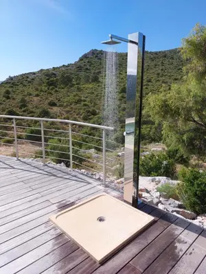 a shower on a wooden deck with a mountain in the background at Alzina in Vingrau