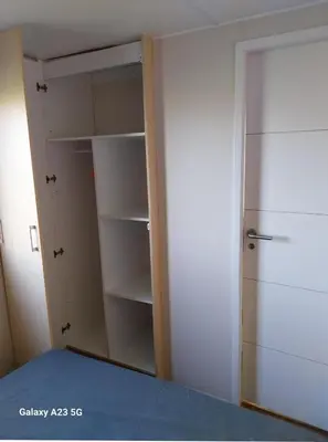 a bedroom with a closet with a door open at Mobil-home Port la Nouvelle in Port-la-Nouvelle
