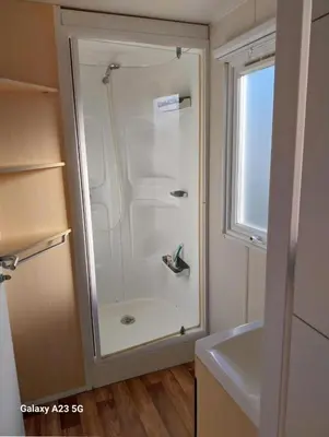 a bathroom with a shower and a sink at Mobil-home Port la Nouvelle in Port-la-Nouvelle