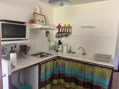 a small kitchen with a stove and a microwave at Maison de Vacances in Pradelles-Cabardès