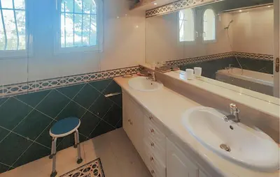 a bathroom with a sink and a mirror and a stool at Pet Friendly Home In Cruzy in Cruzy