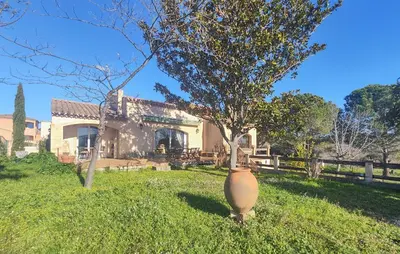 a large vase sitting in the grass in front of a house at Pet Friendly Home In Cruzy in Cruzy