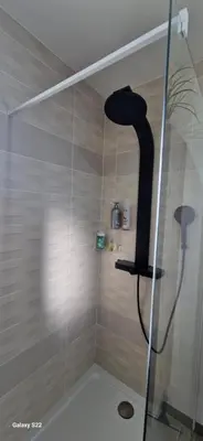 a shower with a black shower head in a bathroom at Villa moderne avec piscine privée in Roubia