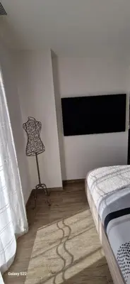 a bedroom with a bed and a television on a wall at Villa moderne avec piscine privée in Roubia