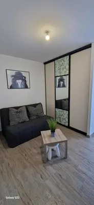 a living room with a couch and a table at Villa moderne avec piscine privée in Roubia