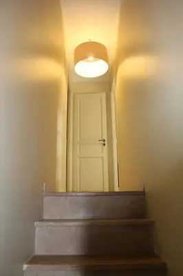 a hallway with a white door and a light at Maison 4 ou 6 personnes au cœur Corbières in Saint-Laurent-de-la-Cabrerisse