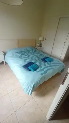 a bed in a bedroom with a blue comforter at Maison 4 ou 6 personnes au cœur Corbières in Saint-Laurent-de-la-Cabrerisse