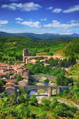 a town with a bridge and a river in a field at Maison 4 ou 6 personnes au cœur Corbières in Saint-Laurent-de-la-Cabrerisse