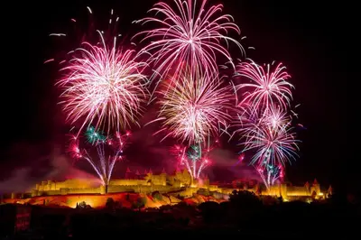 a fireworks display with a castle in the background at Au Pied des Remparts-Cité Médiévale in Carcassonne