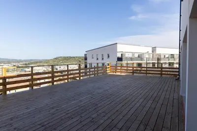 a balcony of a building with a wooden deck at Instant villa Serenity - 8 people with a view in Narbonne