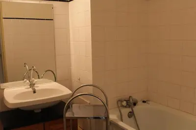 a bathroom with a sink and a bath tub at Appartement avec grande terrasse vue panoramique GN400-024 in Gruissan