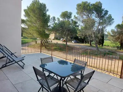 a patio with a table and chairs and a fence at House on winery in Azille