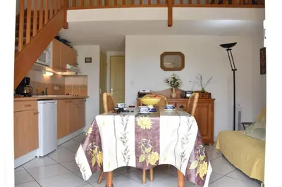 a kitchen with a table with a table cloth on it at Villa avec terrasse et garage proche plage GA120-038 in Gruissan