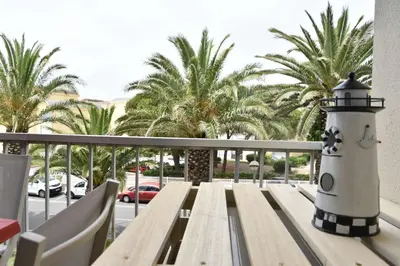 a lighthouse sitting on top of a bench on a balcony at Appartement 2 pièces - Gruissan GN580-028 in Gruissan
