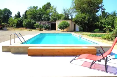 a swimming pool with a chair and a table and a chair at Villa Le Jardin des Délices - de 2 à 8 personnes avec Piscine in Raissac-dʼAude