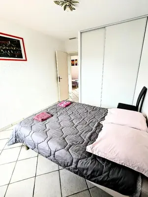 a bedroom with a large bed in a room at Villa Le Jardin des Délices - de 2 à 8 personnes avec Piscine in Raissac-dʼAude