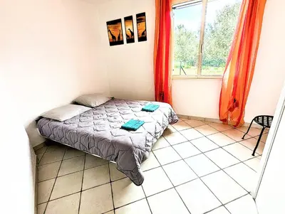 a small bedroom with a bed and a window at Villa Le Jardin des Délices - de 2 à 8 personnes avec Piscine in Raissac-dʼAude