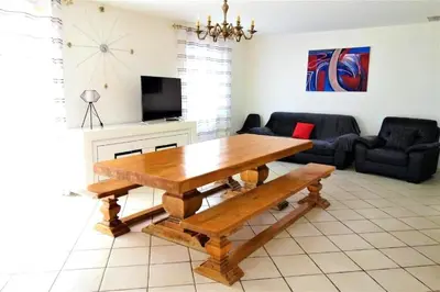 a living room with a wooden table and a couch at Villa Le Jardin des Délices - de 2 à 8 personnes avec Piscine in Raissac-dʼAude