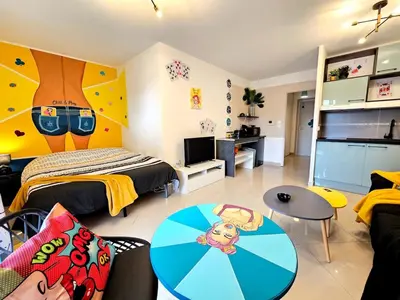 a bedroom with a bed and a table in a room at POP ART Casino vibe! in Gruissan