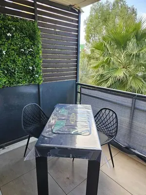 a blue table and two chairs on a balcony at POP ART Casino vibe! in Gruissan