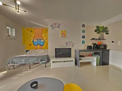a living room with a bed and a tv at POP ART Casino vibe! in Gruissan