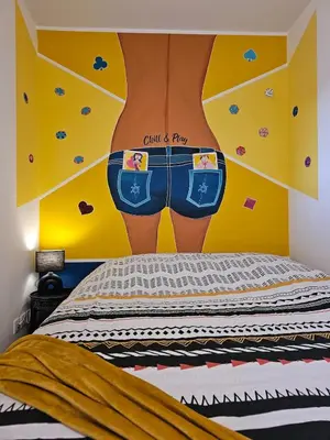 a bedroom with a wall with a picture of a man in shorts at POP ART Casino vibe! in Gruissan
