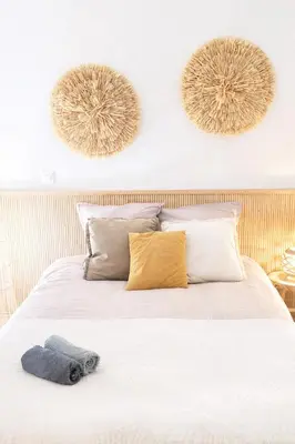 a bedroom with a bed with two mirrors on the wall at Les Cèdres - grand studio - neuf in Castres