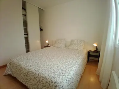 a bedroom with a bed and two lamps on tables at villa 2 chambres en rez-de-jardin in Puylaurens