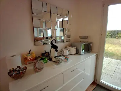a kitchen with a counter top with a microwave at villa 2 chambres en rez-de-jardin in Puylaurens