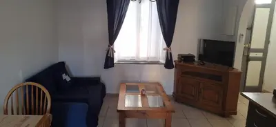a living room with a blue couch and a table at Charming Apartment in La Redorte in La Redorte