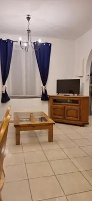 a living room with a coffee table and a tv at Charming Apartment in La Redorte in La Redorte
