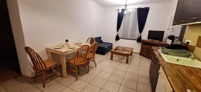 a kitchen with a table and chairs in a room at Charming Apartment in La Redorte in La Redorte