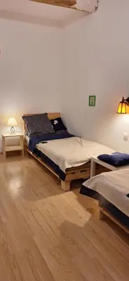 a room with two beds and a lamp in it at Charming Apartment in La Redorte in La Redorte