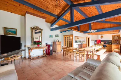 a living room with a couch and a table at Le Coteau Ensoleillé - Climatisée avec piscine in Carcassonne
