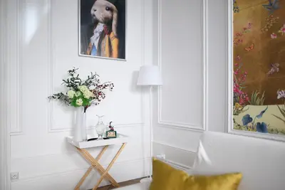 a living room with a vase of flowers on a table at le RAMOND in Carcassonne