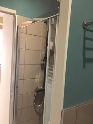 a bathroom with a shower with a mirror at L'Autan sage in Montgeard
