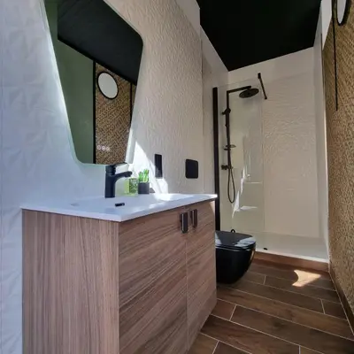 a bathroom with a sink and a shower and a toilet at La Bulle Carrée - Centre Historique médiéval - in Lapalme