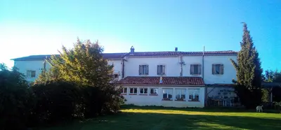 a large white house with trees in front of it at Fossat in Villautou