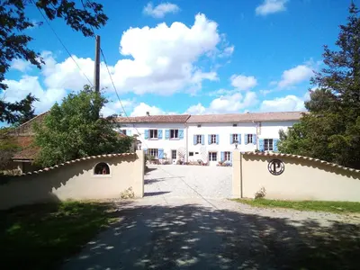 a large white building with a fence in front of it at Fossat in Villautou