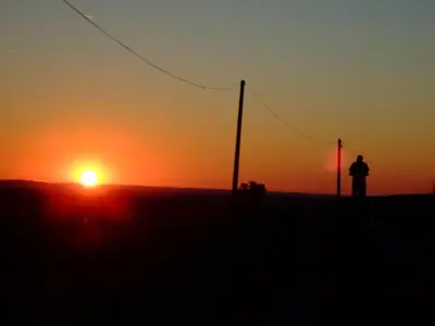 a person standing in front of a sunset at Fossat in Villautou