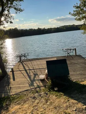 a dock on a lake with two bikes on it at Lac de Latournerie in Cazals-des-Baylès