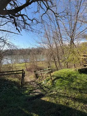 a wooden fence in a field near a river at Lac de Latournerie in Cazals-des-Baylès