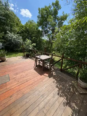 a wooden deck with a table and a bench on it at Lac de Latournerie in Cazals-des-Baylès