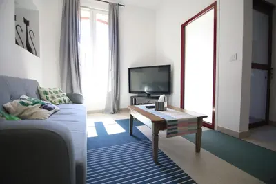 a living room with a couch and a coffee table at T3 de 70m2 avec sauna, piscine intérieure chauffée in Siran