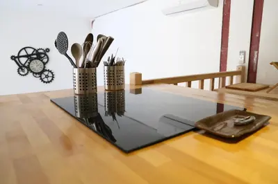 a glass table with some utensils on top of it at T3 de 70m2 avec sauna, piscine intérieure chauffée in Siran