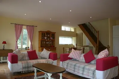 a living room with two couches and a table at Argein in Villautou
