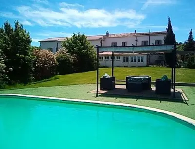 a swimming pool in front of a house at Argein in Villautou