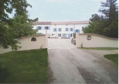 a large white house with a driveway at Argein in Villautou